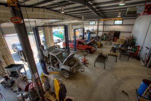 Vehicles being dismantled in a shop at an auto recycler 