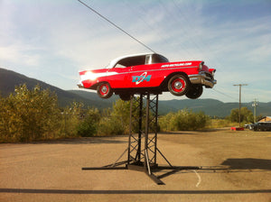 red vintage car display at an auto recycler 